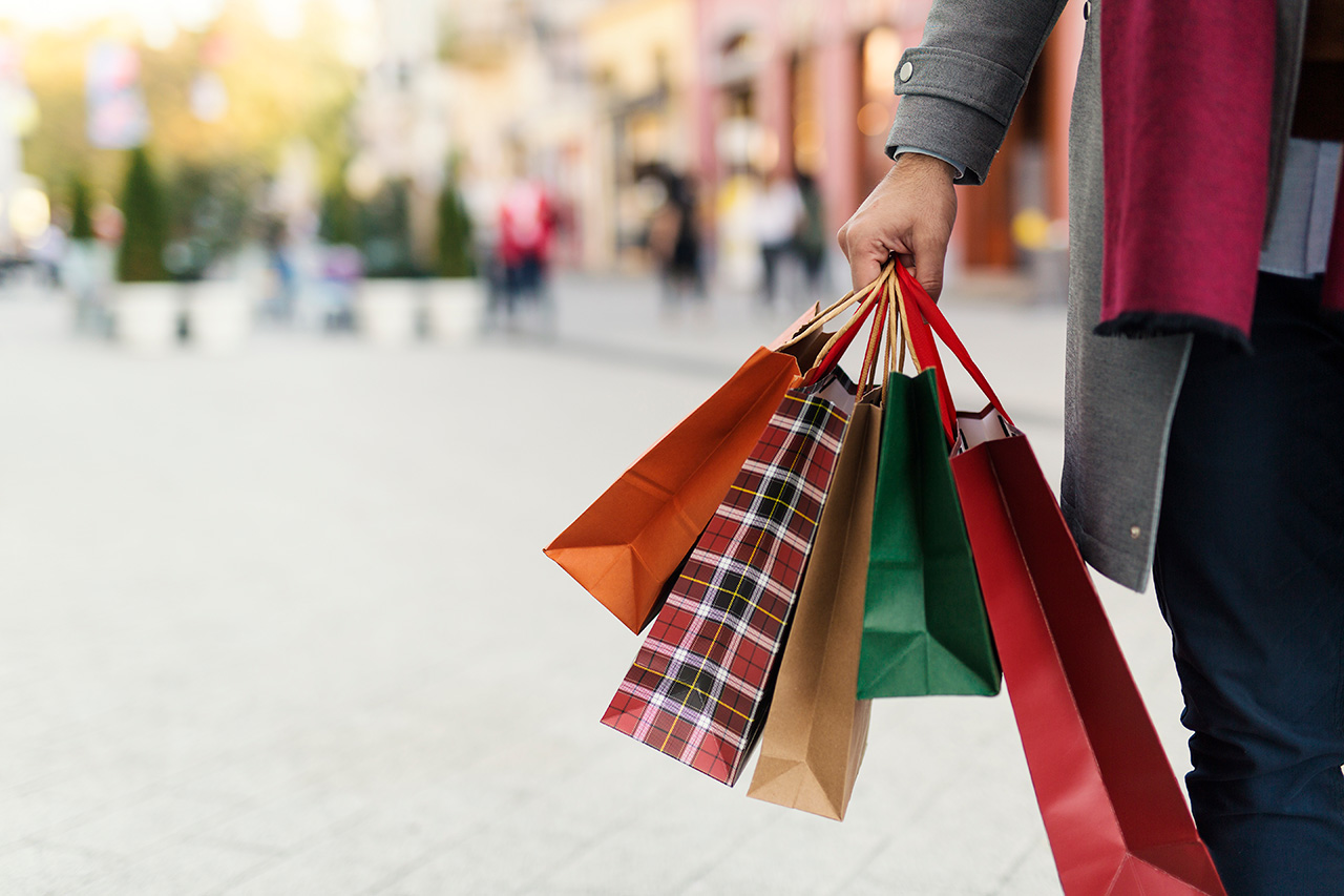 man holding shopping bags